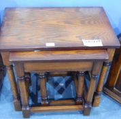 A nest of three oak tables