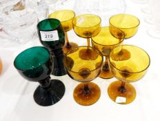 Set of six amber glass champagne saucers and two various green glass rummers