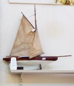 A wooden pond yacht "Speedwell" having rudder with raised masts and sails,