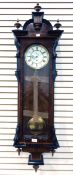 A mahogany and ebonised Vienna regulator wall clock with broken-arch top with turned finials,