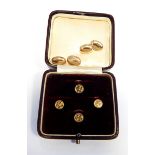 Set of four gold coloured studs,