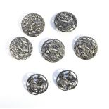 Set of five Edwardian silver buttons, circular, pierced and embossed, bird and flower decoration,