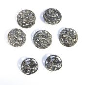 Set of five Edwardian silver buttons, circular, pierced and embossed, bird and flower decoration,