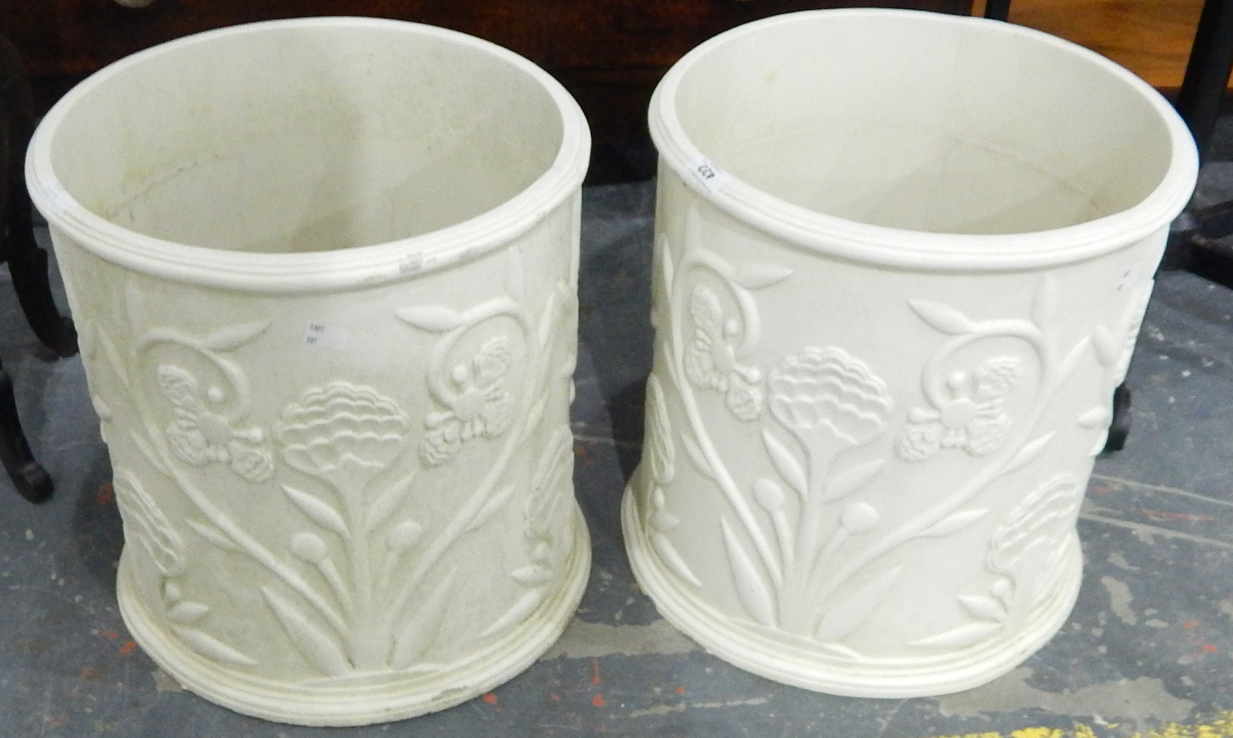 A pair of modern moulded cylindrical patio planters with applied floral and foliate decoration in - Image 2 of 2