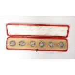 Set of six Edwardian silver floral buttons, Birmingham 1902 by Strauss & Barder,