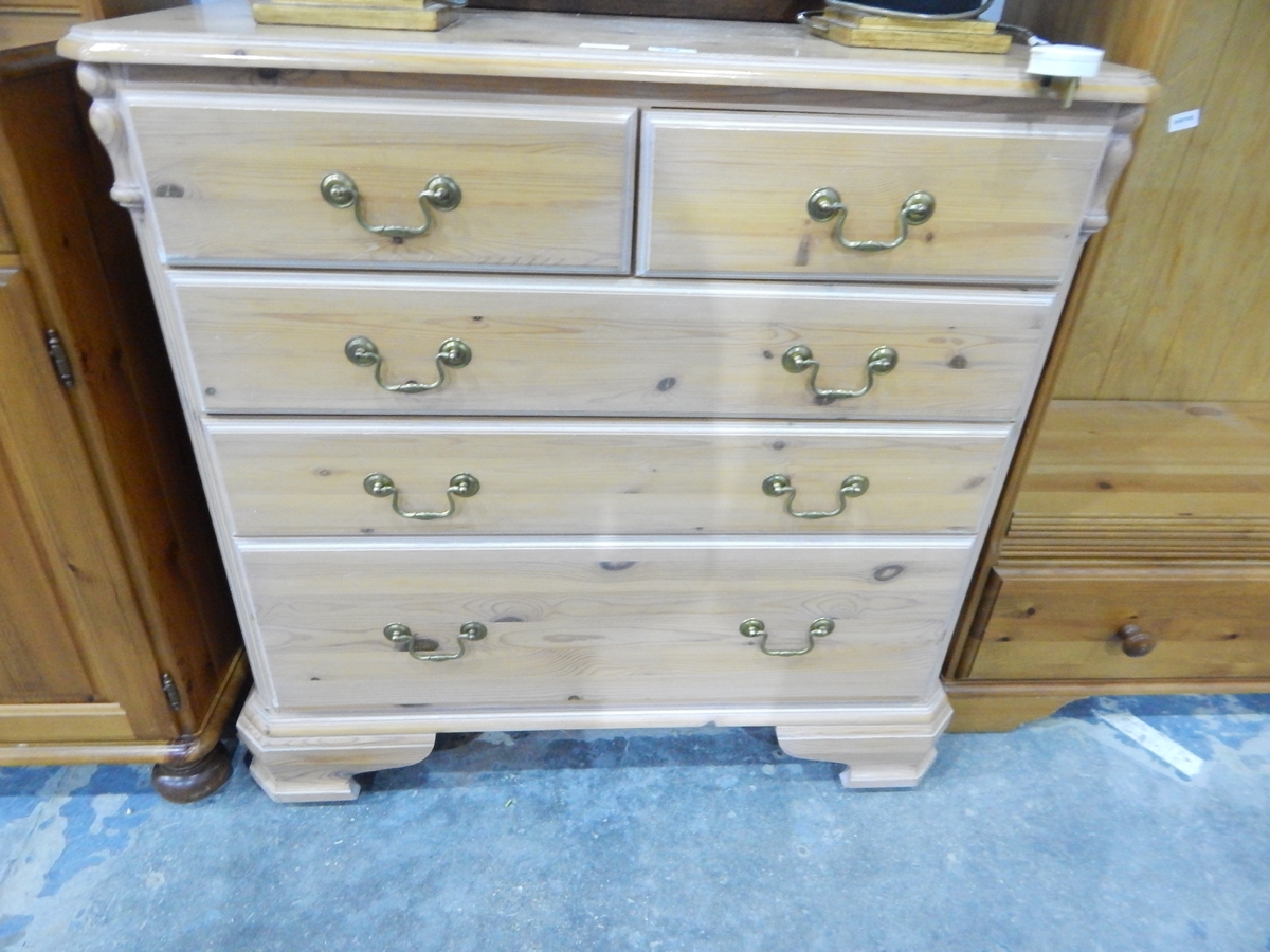 A pine chest of two short and three graduated long drawers,