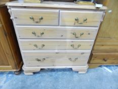 A pine chest of two short and three graduated long drawers,