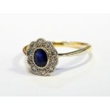 Sapphire and diamond cluster ring set oval facet-cut sapphire and surround of ten tiny diamonds,