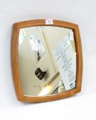 Cotswold School polished wood wall mirror of square cushion-shape in the manner of Hugh Birkett