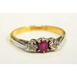 A three-stone diamond and ruby dress ring with 18ct gold shank