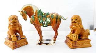A Chinese pottery replica model of a "Tang" horse (af) and a pair of pottery models of Dogs of Fo