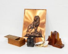 A copper plaque of a lion, oyster shells, badges, binoculars,