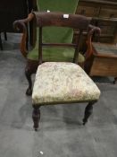 A dining chair with floral patterned seat,