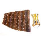 An African shell and beadwork skin apron type panel with metal charm adornments,