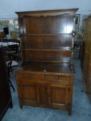 An early 20th century oak linenfold panel dresser by L Marcus Ltd, London,