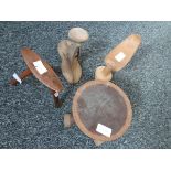 A collection of African tribal wooden headrests, some of pedestal form,