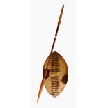 An African animal skin shield with woven decoration and a carved wooden spear