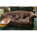 A modern two seater sofa with tartan cover,