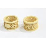 Two Oriental carved ivory napkin rings,