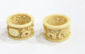 Two Oriental carved ivory napkin rings,