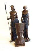 A reproduction bronzed-effect head of Nefertiti and a pair of reproduction bronzed-effect African