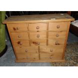 A pine chest of 13 short drawers together with a cast iron fireback depicting a flower with