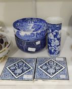 A pair of Mintons blue and white tiles decorated with flowers in vases,