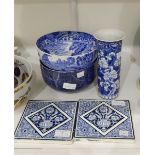 A pair of Mintons blue and white tiles decorated with flowers in vases,