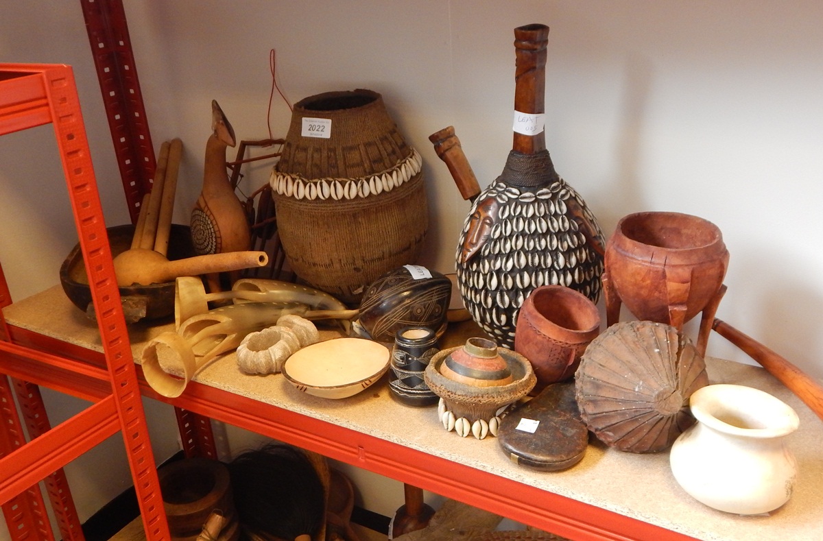 A quantity of African carved wooden vessels including some with shell decoration,