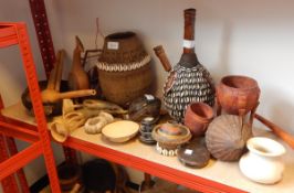 A quantity of African carved wooden vessels including some with shell decoration,