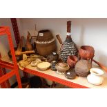 A quantity of African carved wooden vessels including some with shell decoration,