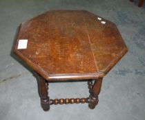 An octagonal topped occasional table on bulbous and block supports united by turned supports