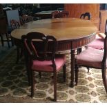 A set of six Victorian mahogany balloon back dining chairs and one carver with pink floral cushions,