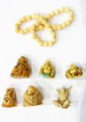 A small jade fish, carved netsuke of crouching wise gentleman, three other netsuke,