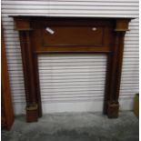 An oak fireplace with circular reeded columns,