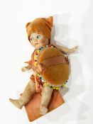 A small bisque doll pin cushion, the bisque doll with painted features, jointed limbs,