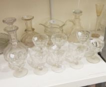 A pair of 19th century slab cut glass decanters, a 19th century cut glass jug, drinking glasses,