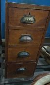 An oak side cabinet of four drawers with fluted handles,