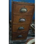 An oak side cabinet of four drawers with fluted handles,