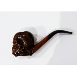 A carved wooden pipe, the bowl in the form of skull supported on lady's hand, the case marked "Gebr.