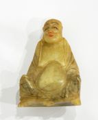An Oriental carved jade seated figure of a sage,