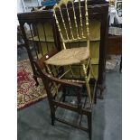 A gilt stickback chair, rush seated,