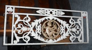 A pair of French cast iron panels showing acanthus with a drinking cherub in the centre
