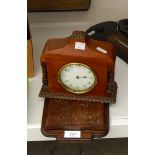 A mahogany mantel timepiece with inset carved columns,