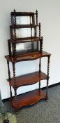 A 19th century rosewood mirror backed whatnot with two serpentine undershelves,