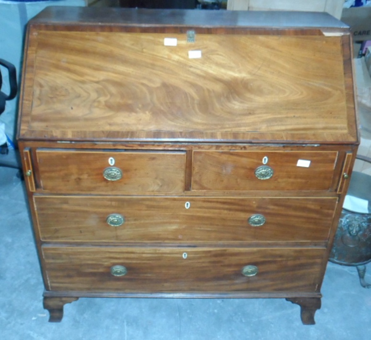 A mahogany bureau, the writing slope reveals fitted interior,