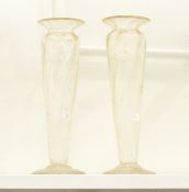 A pair of large glass vases, each of fluted form with cut glass foliage and details,