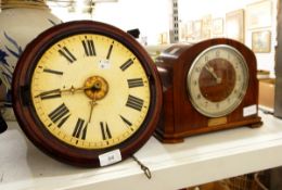 A mahogany framed circular wall clock with painted enamel dial, brass raised central dial,