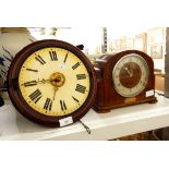 A mahogany framed circular wall clock with painted enamel dial, brass raised central dial,