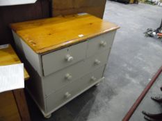 An pine chest of drawers with two short and two long drawers, painted eggshell colour,